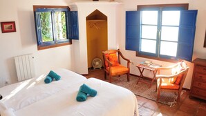 A bedroom with a bed, a chair, a desk, and a wardrobe. - Villa El Tejar - Montecorto, Serrania de Ronda, Spain (Montecorto)