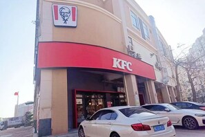 A KFC restaurant with a red awning and a visible logo. - Jinjiang Tianhe Grand Hotel (Jinjing People's Government) (Jinjiang)
