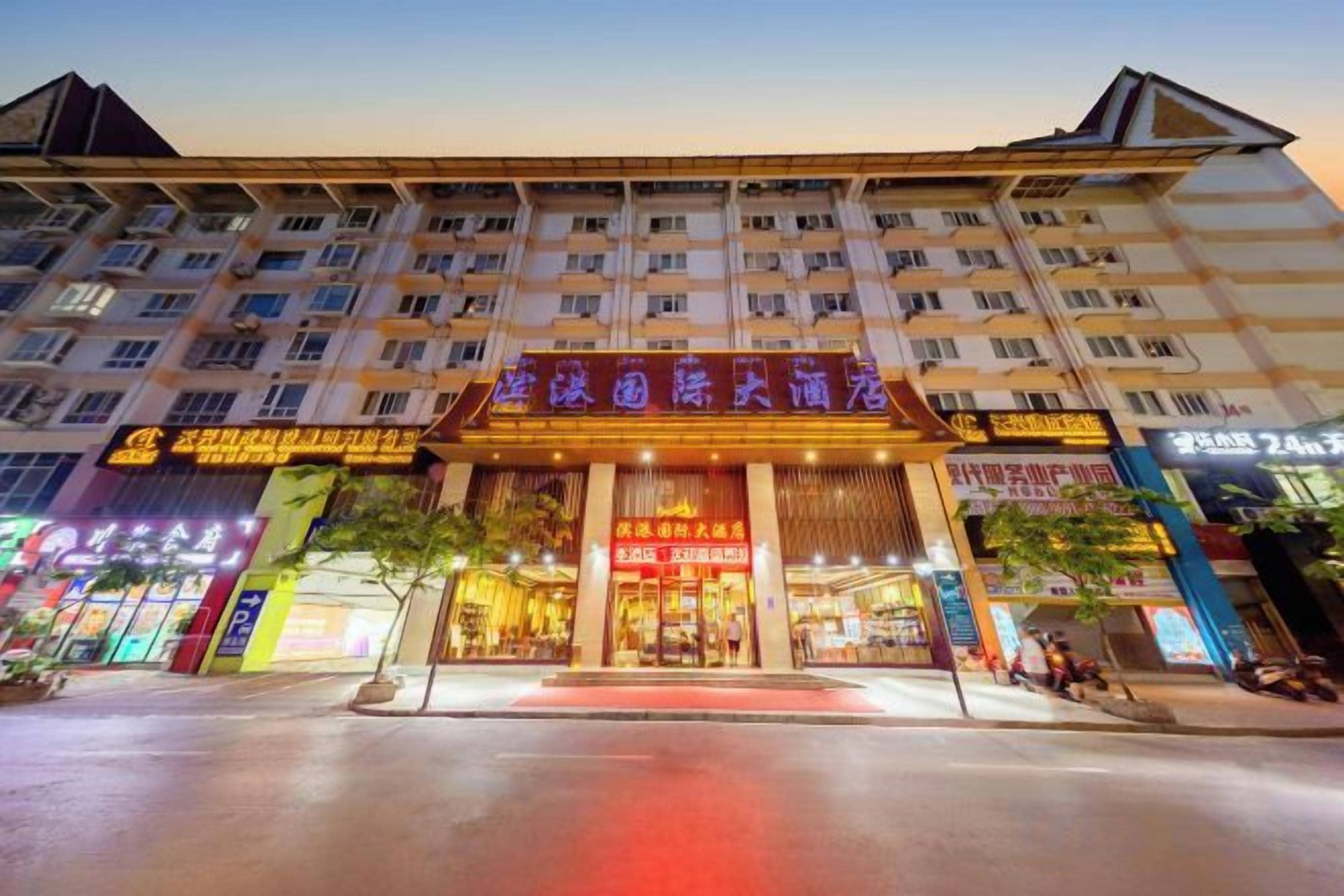 A hotel with multiple floors, a prominent entrance, and various signage.