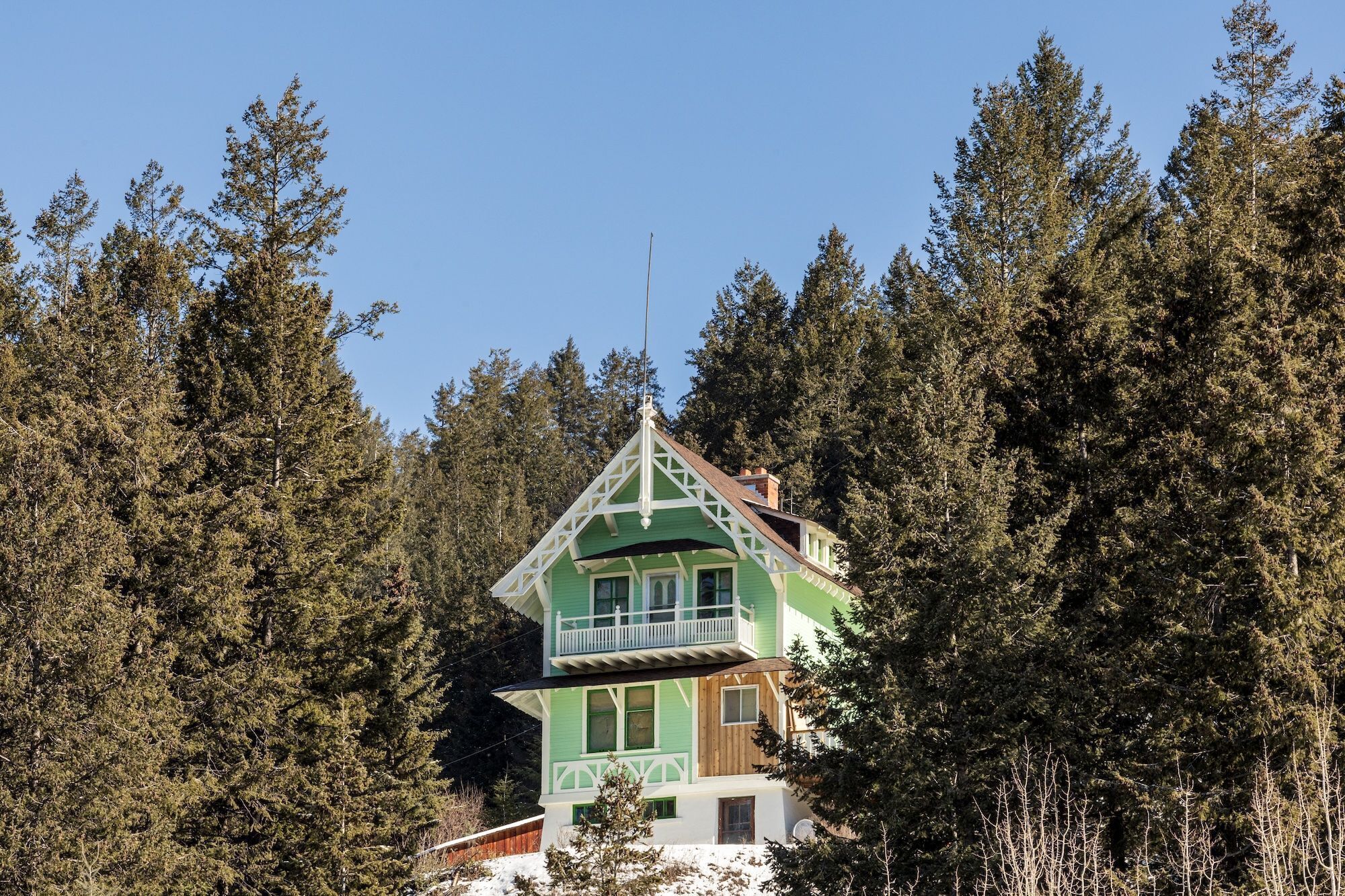 Bask in the sunshine on this enchanting chalet, surrounded by lush green woods and blue skies.