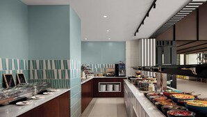 A modern kitchen with a buffet setup, including various food stations and a coffee machine. - Courtyard By Marriott Dakar Diamniadio (Diamniadio)