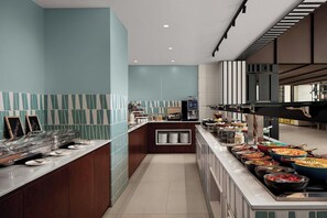 A modern kitchen with a buffet setup, including various food stations and a coffee machine. - Courtyard By Marriott Dakar Diamniadio (Diamniadio)