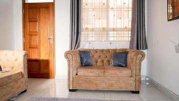 Elite Apartment, City View | Living area | 24-inch Smart TV with digital channels