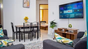 Deluxe Apartment, City View | Living area | 24-inch Smart TV with digital channels