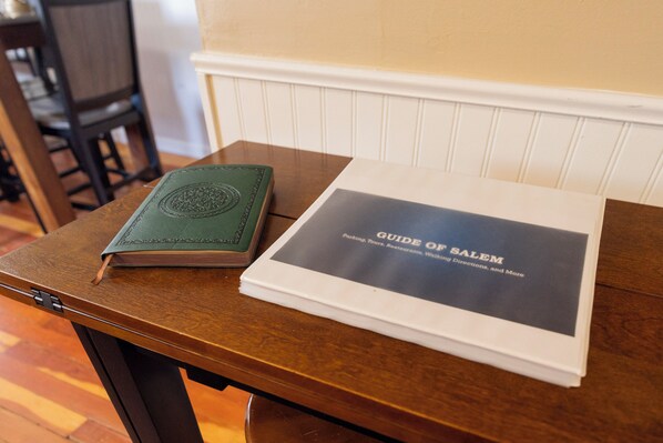 A guidebook titled "Guide of Salem" on a wooden table. - Ravens Hollow- Enchanting 2-bedroom condo Near Downtown Salem (Salem)