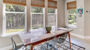 A dining area with a glass table, chairs, and a bowl. There are three windows with blinds, and a rug on the floor. - Spacious Heber Springs Home - Easy Marina Access! (Heber Springs)