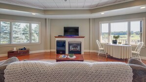 A living room with a fireplace, television, and dining area with a table and chairs. - 'holmes With a View' Studio: Millersburg Retreat! (Millersburg)