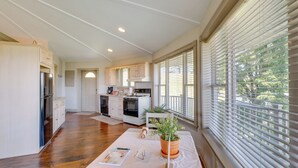 A spacious kitchen with white cabinets, a central island, and a dining area with a table and chairs. - Millersburg Getaway w/ Amish Country Views! (Millersburg)
