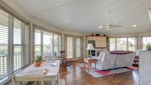 A spacious living area with a dining table, a sofa, and a kitchen in the background. - Millersburg Getaway w/ Amish Country Views! (Millersburg)