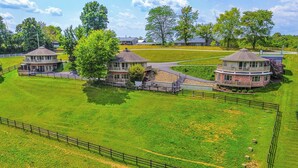 A large, fenced property with multiple buildings, including a central tower-like structure and several smaller buildings. - ~ 4 Mi to German Market: Millersburg Retreat (Millersburg)