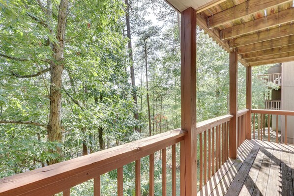 A wooden deck with a view of a forest. - Bryce Resort Getaway w/ Sauna, 1 Mi to Lake Beach! (Basye)