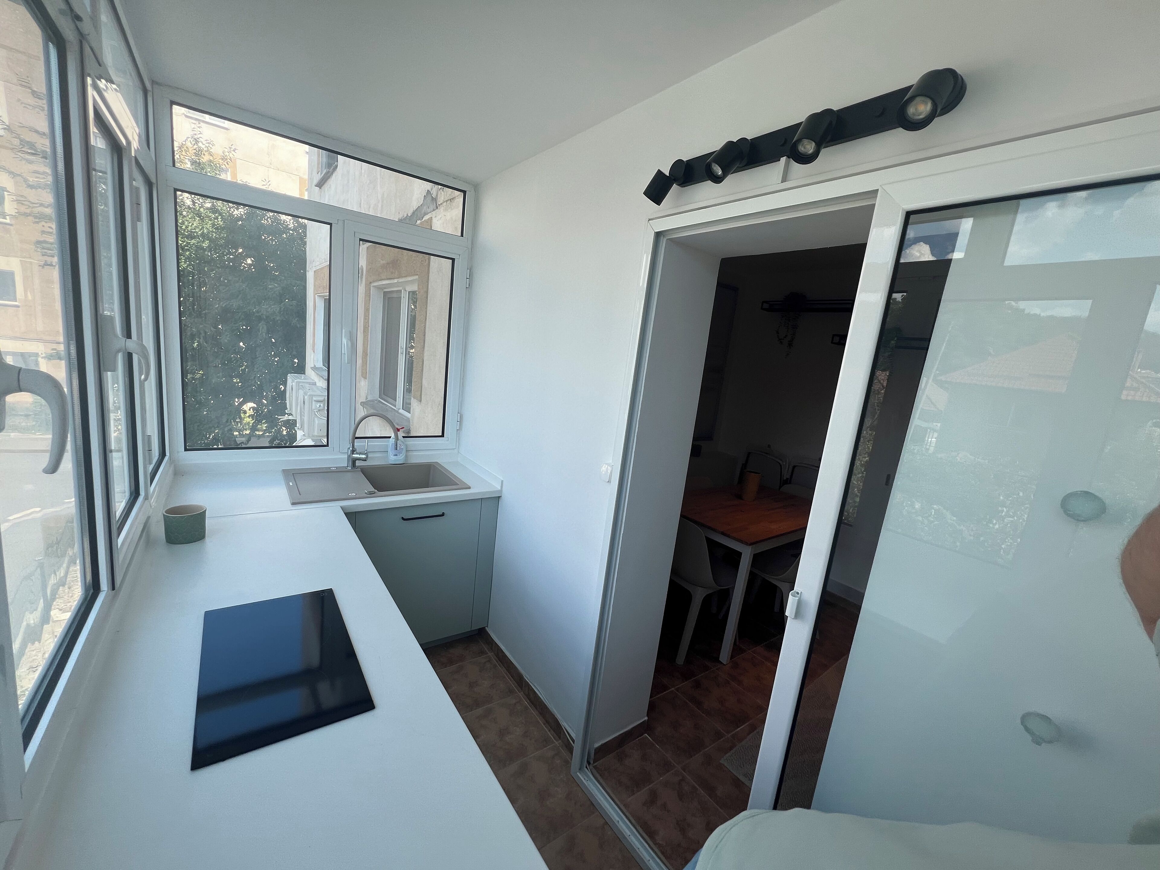 A compact kitchen with a window, a sink, and a small countertop.