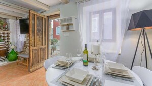 A dining area with a table set for four, a bottle of wine, and a candle on the table. - Rustic Casa Dvi Mendule with swimming pool (Nova Vas)