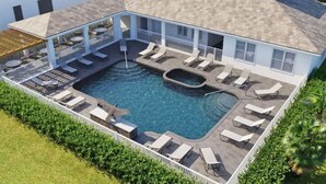 Un área de piscina en la azotea con sillones de descanso y una bañera de hidromasaje.