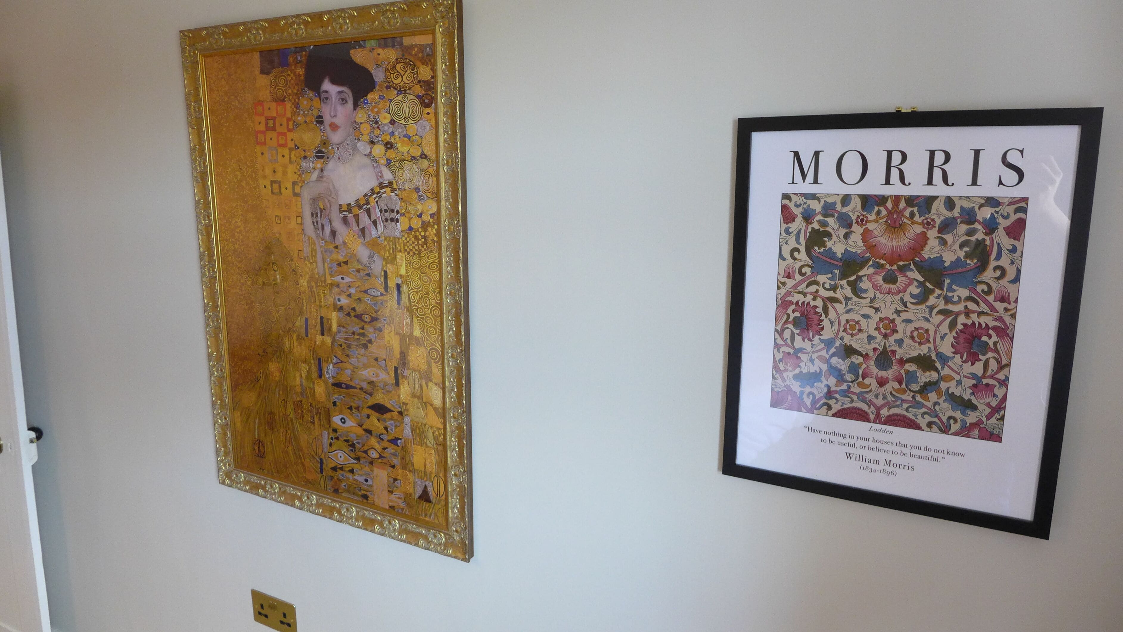 Two framed artworks on a wall.