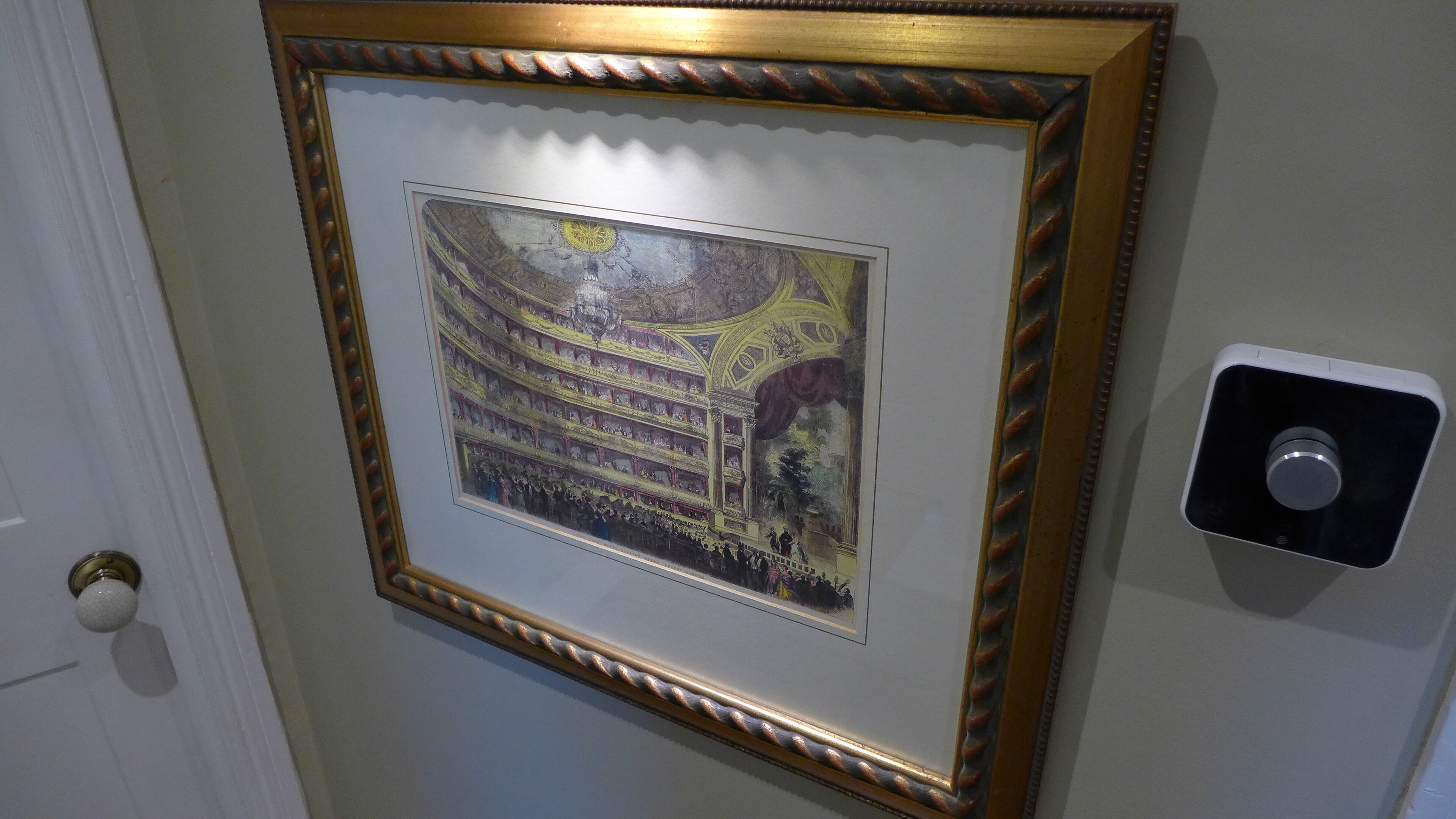 A framed artwork of a theater on a wall.