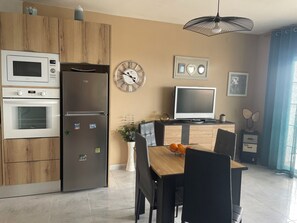 Enjoy cooking and dining in this modern kitchen with appliances and a spacious dining area.