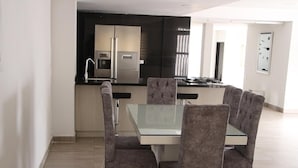 A modern kitchen with a double-door refrigerator, a built-in oven, and a gas stove. - CASA LAURELES ESTADIO MEDELLIN (Medellín)