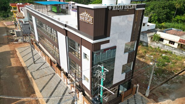 A modern building with a sign reading "MAGAN ENCLAVE GROUP OF MAGANIA". - Magan Enclave (Tarangambadi)