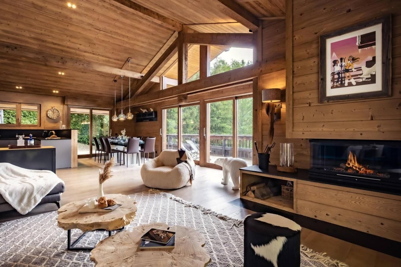 A spacious living area with a fireplace, a dining area, and a kitchen.