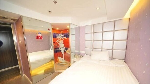 A modern hotel room with a large bed, a glass partition, and a bathroom visible through the partition. - Zenghuage(Urban forest)Theme Hotels (Zhenjiang)