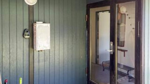 A room with a door, a small window, and a wall-mounted light fixture. - 5 Person Holiday Home in Vejby (Vejby)