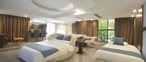 A modern hotel room with two beds, a desk, and a view of the outdoors.