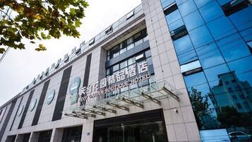 A modern building with a sign for a boutique hotel.