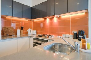 Fridge, microwave, oven, stovetop - Amyra Residences on Rowlands Place - Unit 1202 (Adelaide)