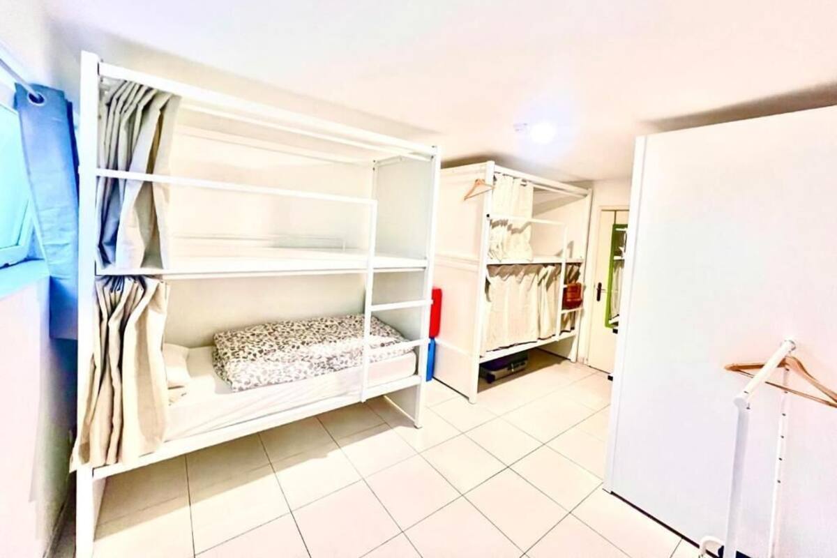 A room with bunk beds and a wardrobe.