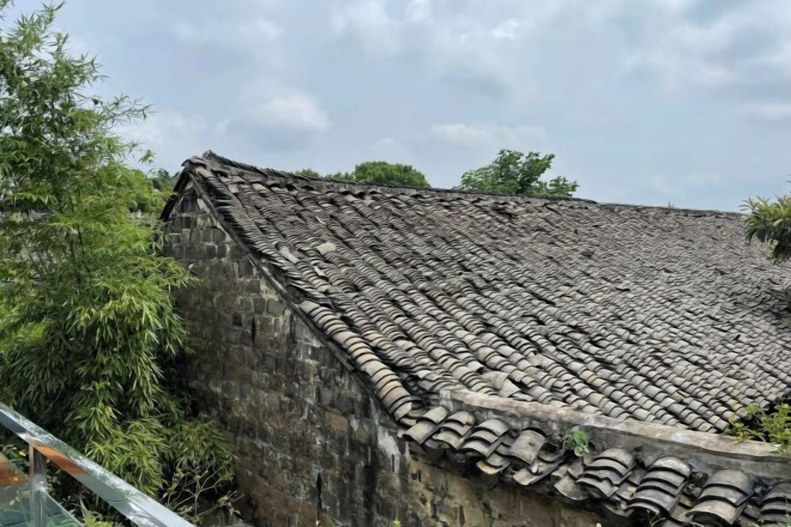A traditional building with a tiled roof and stone walls.
