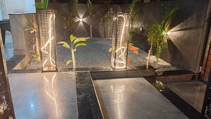 A well-lit indoor garden with a pathway, small plants, and decorative lighting. - Vin Hotels & Service Apartments Manyata Tech Park (Bengaluru)