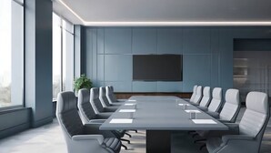 A modern conference room with a long table and multiple chairs, large windows, and a mounted screen on the wall. - Ciatle Suites & Resort  (Dhaka)