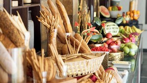 A buffet with various breads, fruits, and a welcome sign. - DGV Resort by Treat, Silvassa (Silvassa)