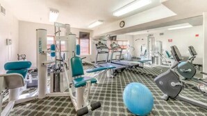 A gym with various exercise equipment, including treadmills, stationary bikes, and weight machines. - Studio Condo at Gateway Lodge in Keystone (Keystone)