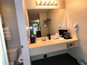 Een haardroger, handdoeken, zeep, toiletpapier