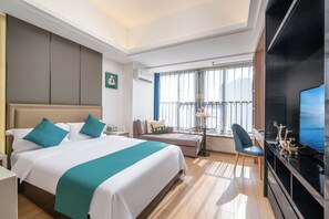 A hotel room with a large bed, a sofa, a TV, and a balcony with a view. - Guangzhou Hantao International Apartment (Guangzhou)