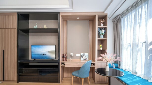 A modern room with a TV, desk, chair, and a window with curtains. - Guangzhou Hantao International Apartment (Guangzhou)