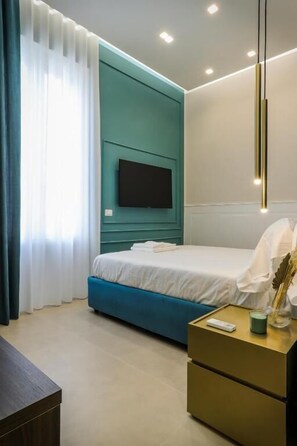 Apartament Deluxe | Caixa forta a l'habitació i escriptori 