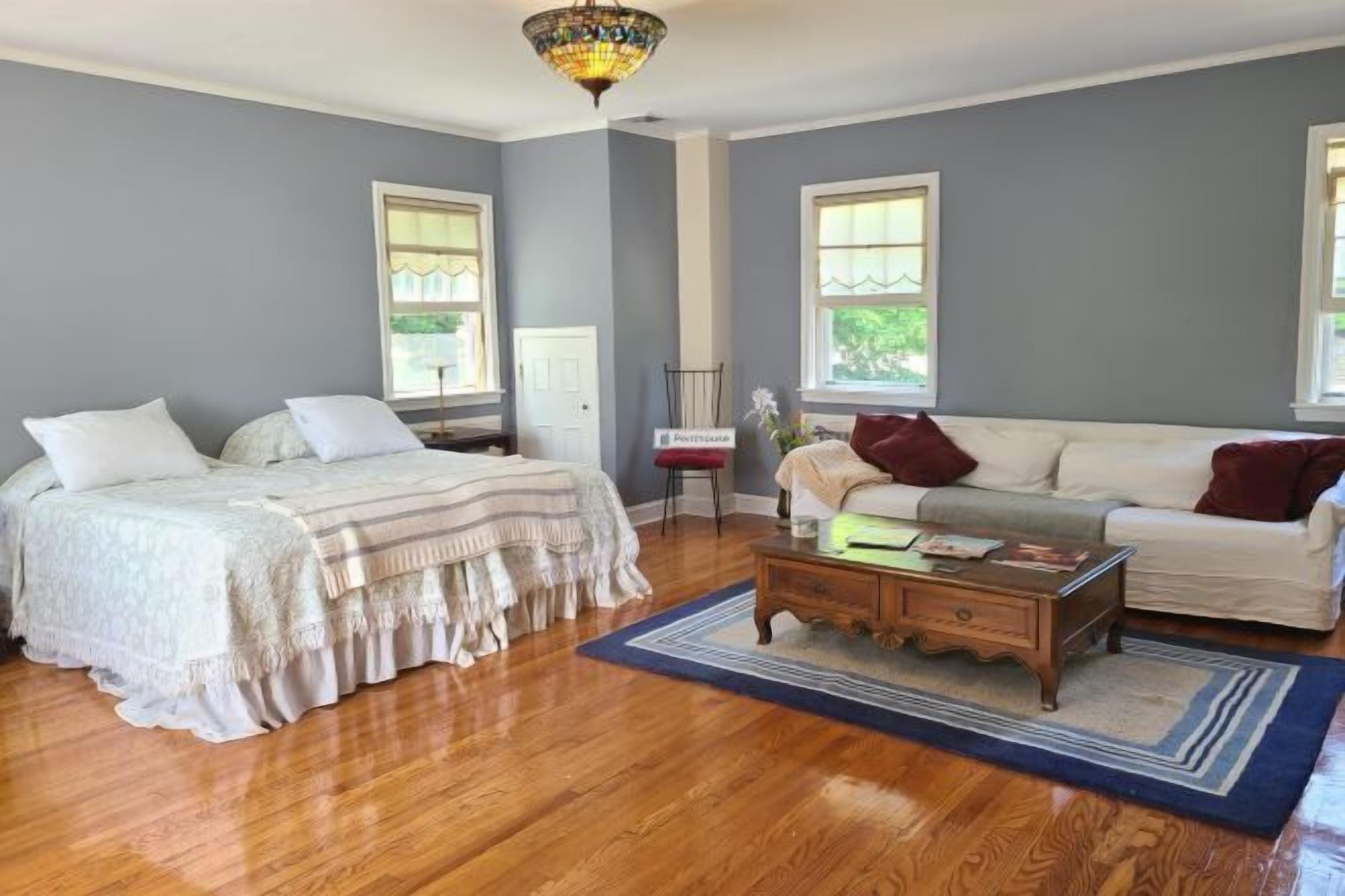 Desk, laptop workspace, blackout drapes, iron/ironing board