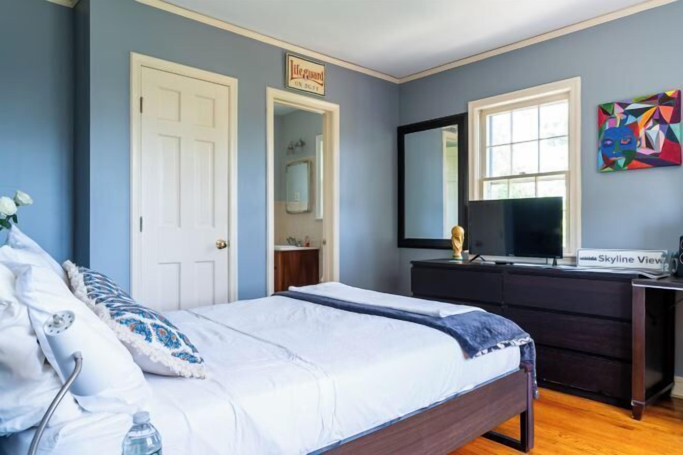 Desk, laptop workspace, blackout drapes, iron/ironing board