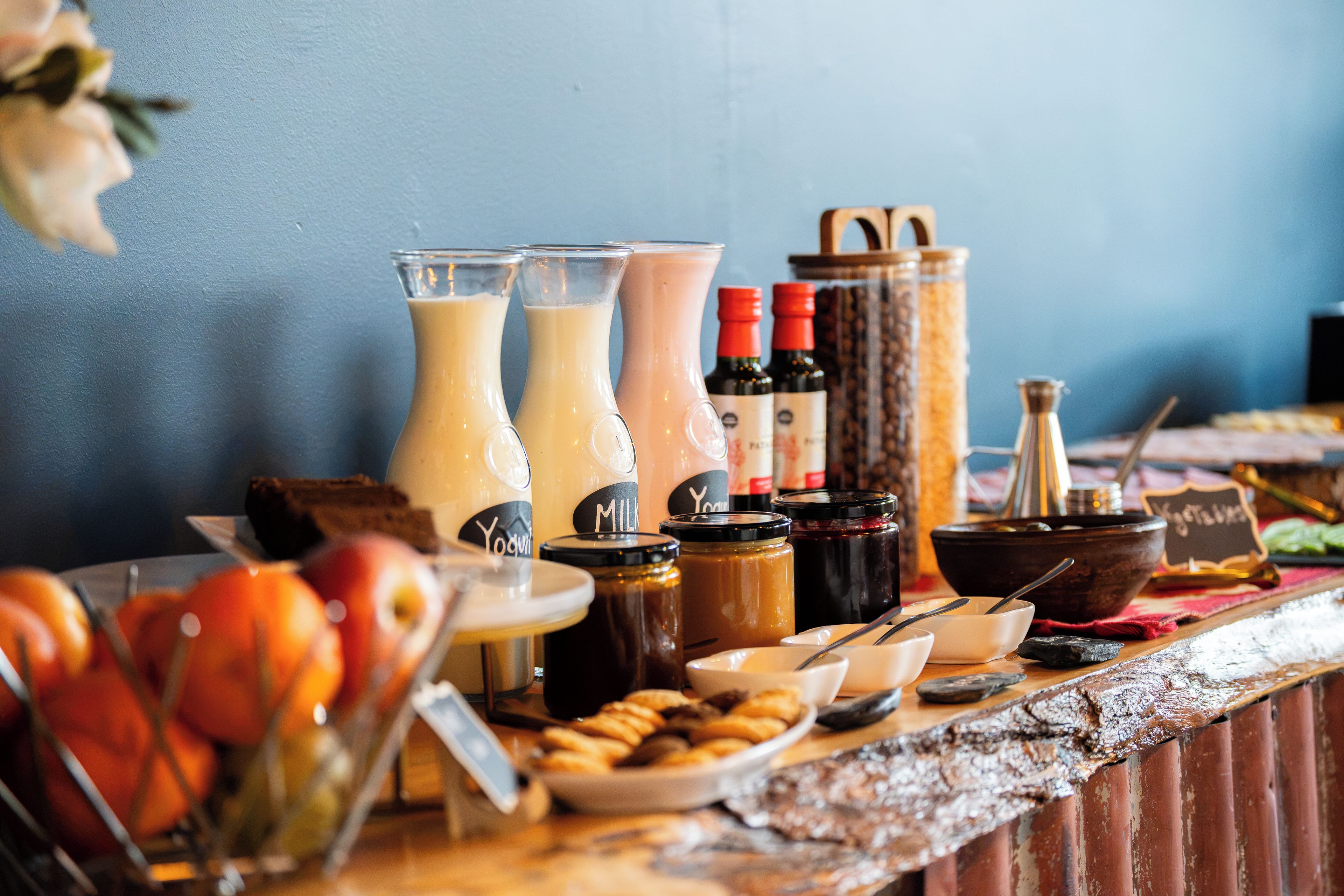 A buffet table with various food items and beverages.