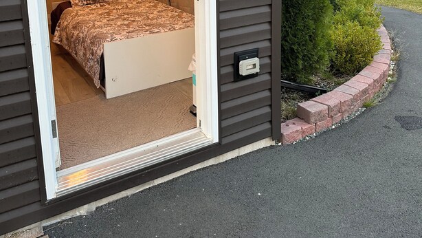 A room with a bed, a small cabinet, and a window with curtains. - Charming small studio in adorable St. John's WiFi access, 2 twin beds, full bath (St. John's)