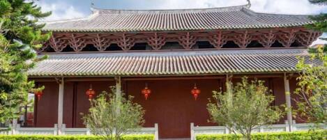A traditional building with a tiered roof and a central entrance.