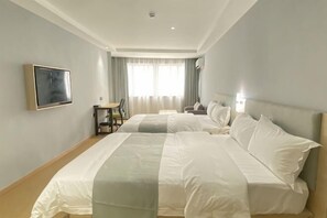A hotel room with two beds, a desk, a chair, a TV, and a window with curtains. - Vanyou Inn (Huzhou Nanxun Ancient Town Shiyuan Road) (Huzhou)
