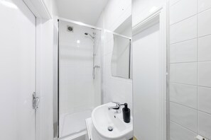 Shower, towels, soap, toilet paper