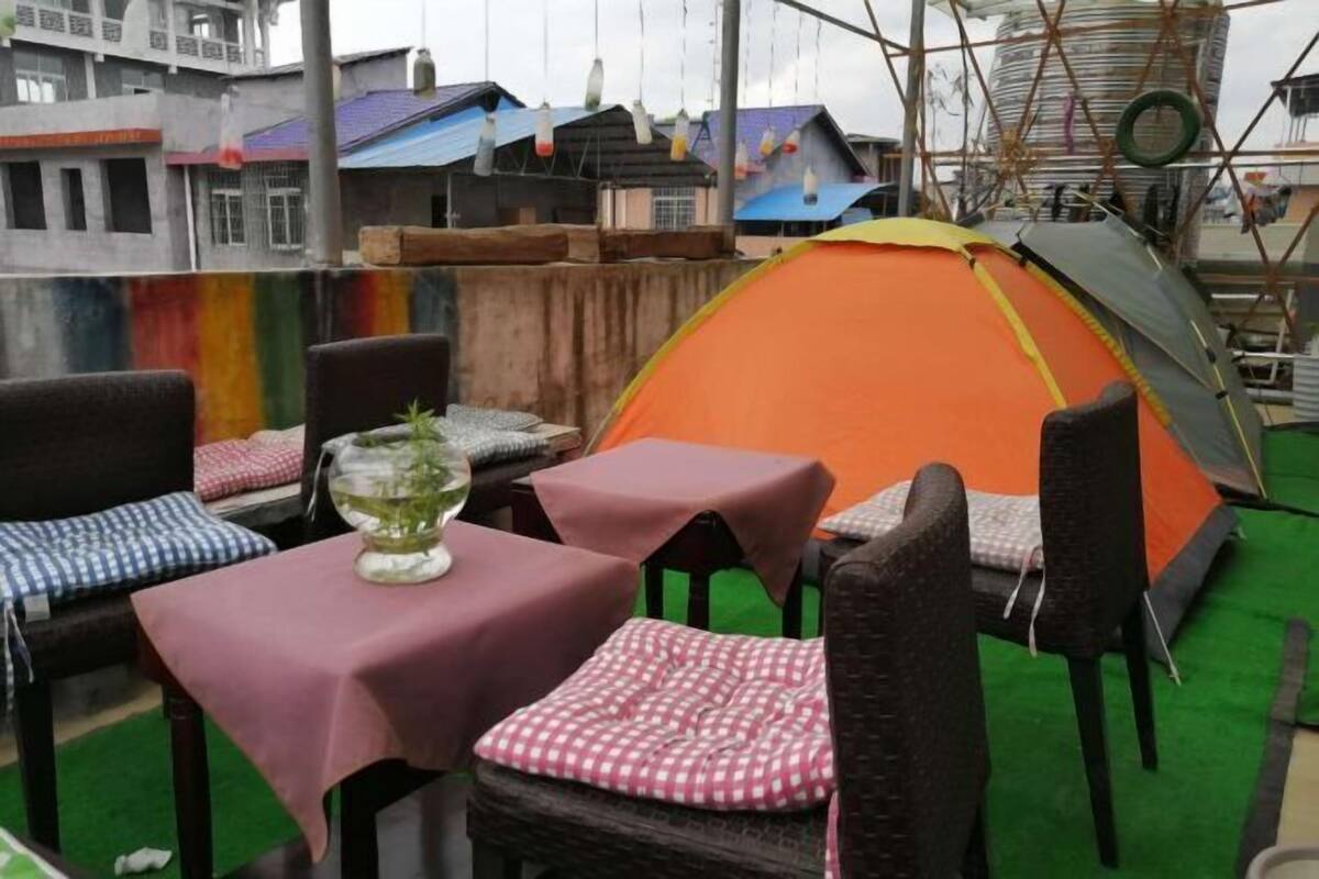 Un espacio al aire libre con una carpa, mesas y sillas.