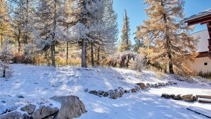 A snow-covered landscape with trees and a stone wall. - Casa-Forêt Blanche, splendide chalet (Risoul)