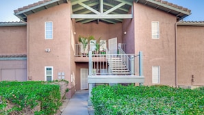 A two-story building with a balcony, a staircase, and a pathway leading to the entrance. - Sunny San Diego Condo w/ Pool Access Near Wineries (San Diego)
