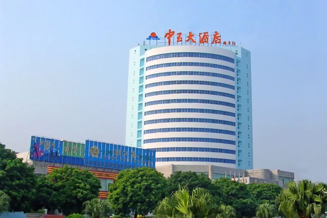 A multi-story hotel with a prominent signage at the top.